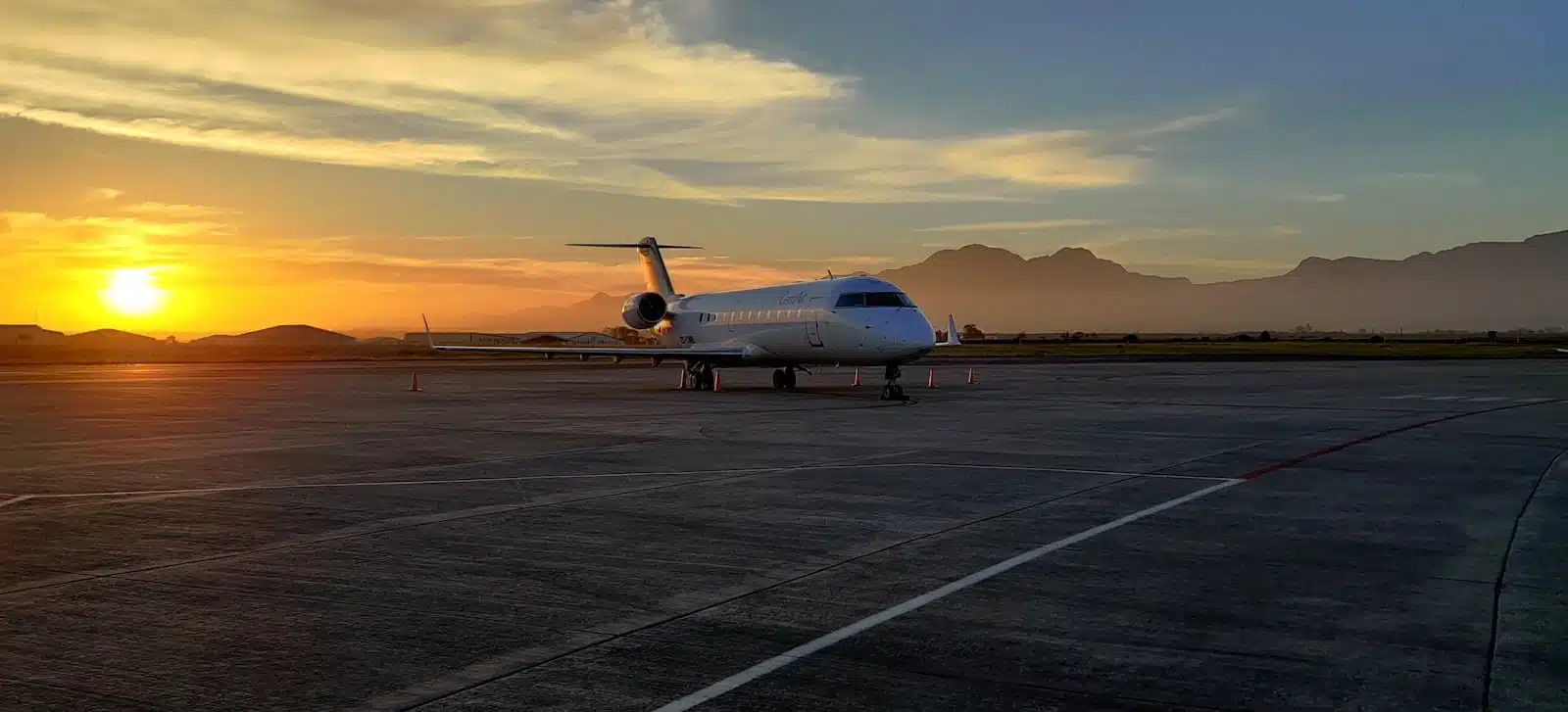 white airplane on airport during sunset