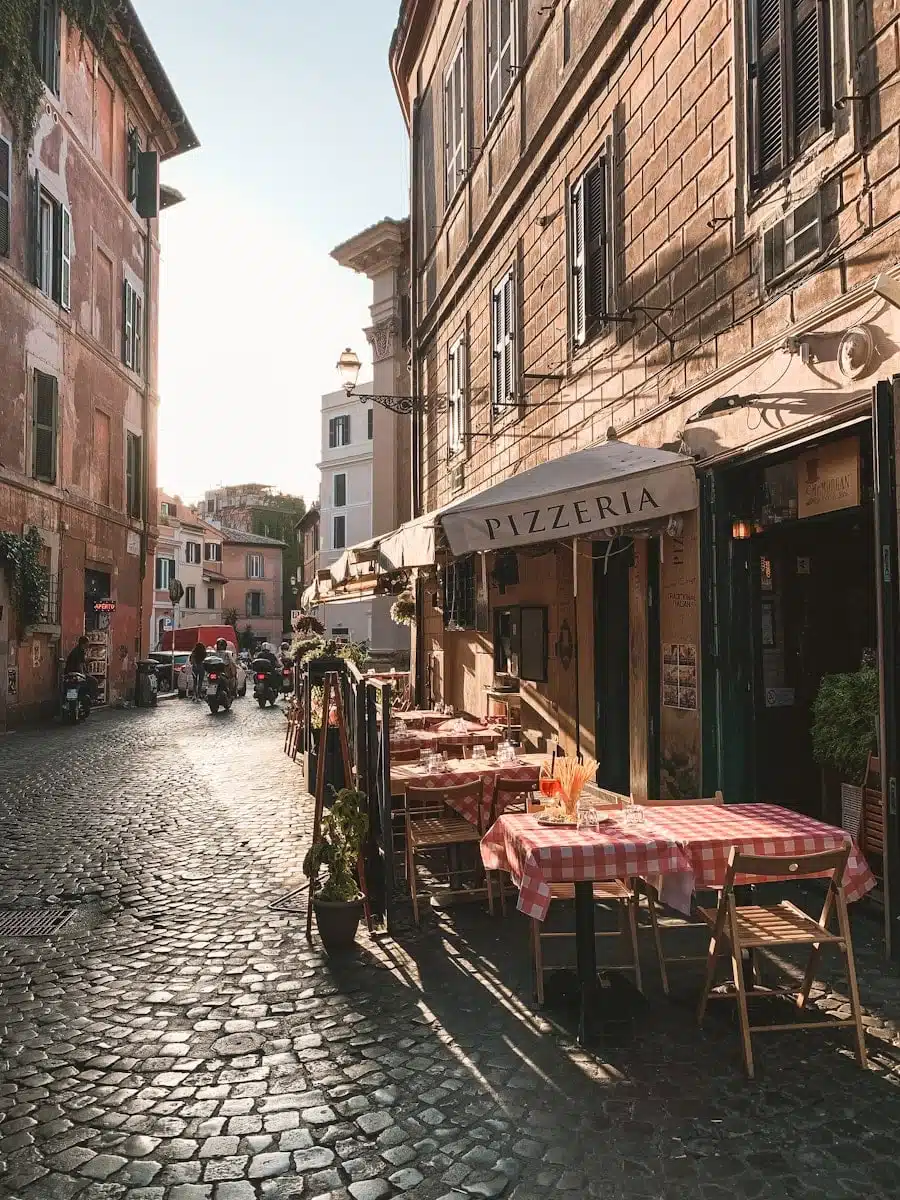 trastevere carriage and table on store front beside houses