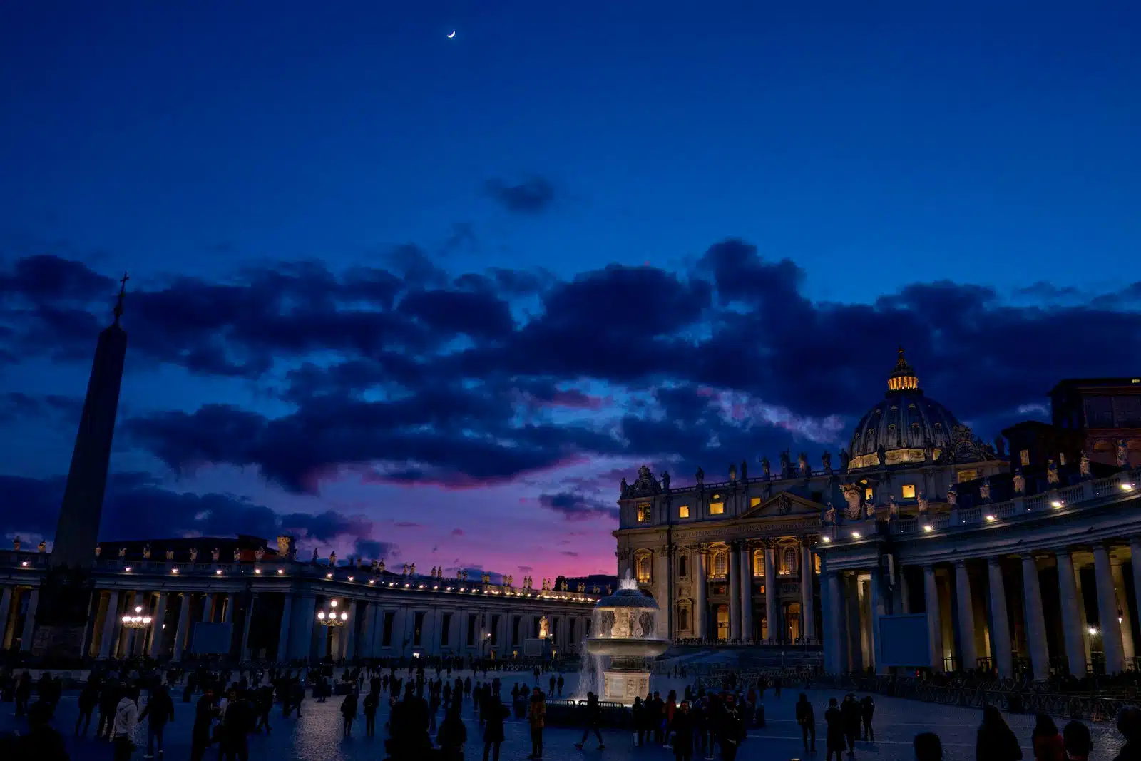 a group of people standing in front of the Vatican