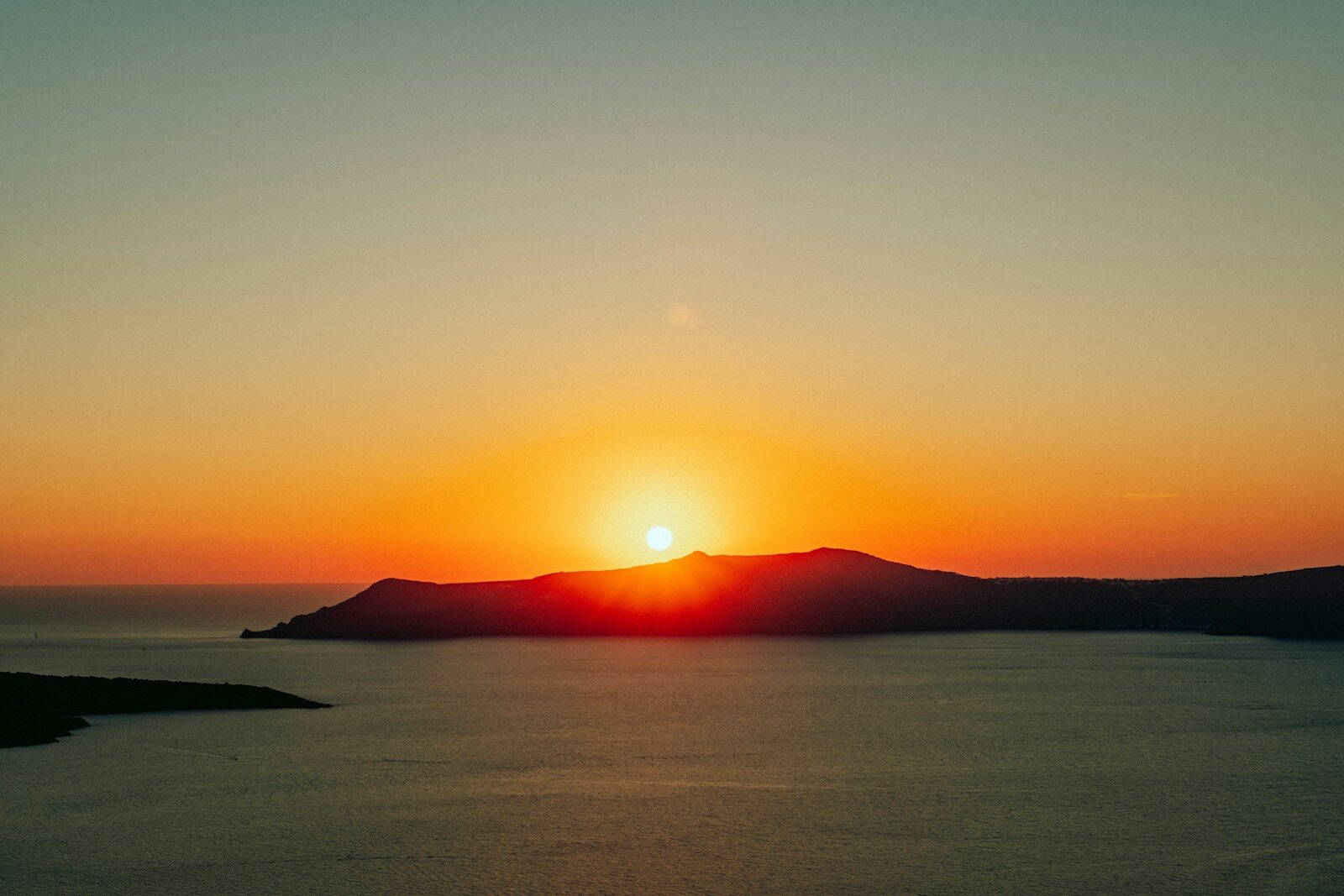 the sun is setting over a body of water