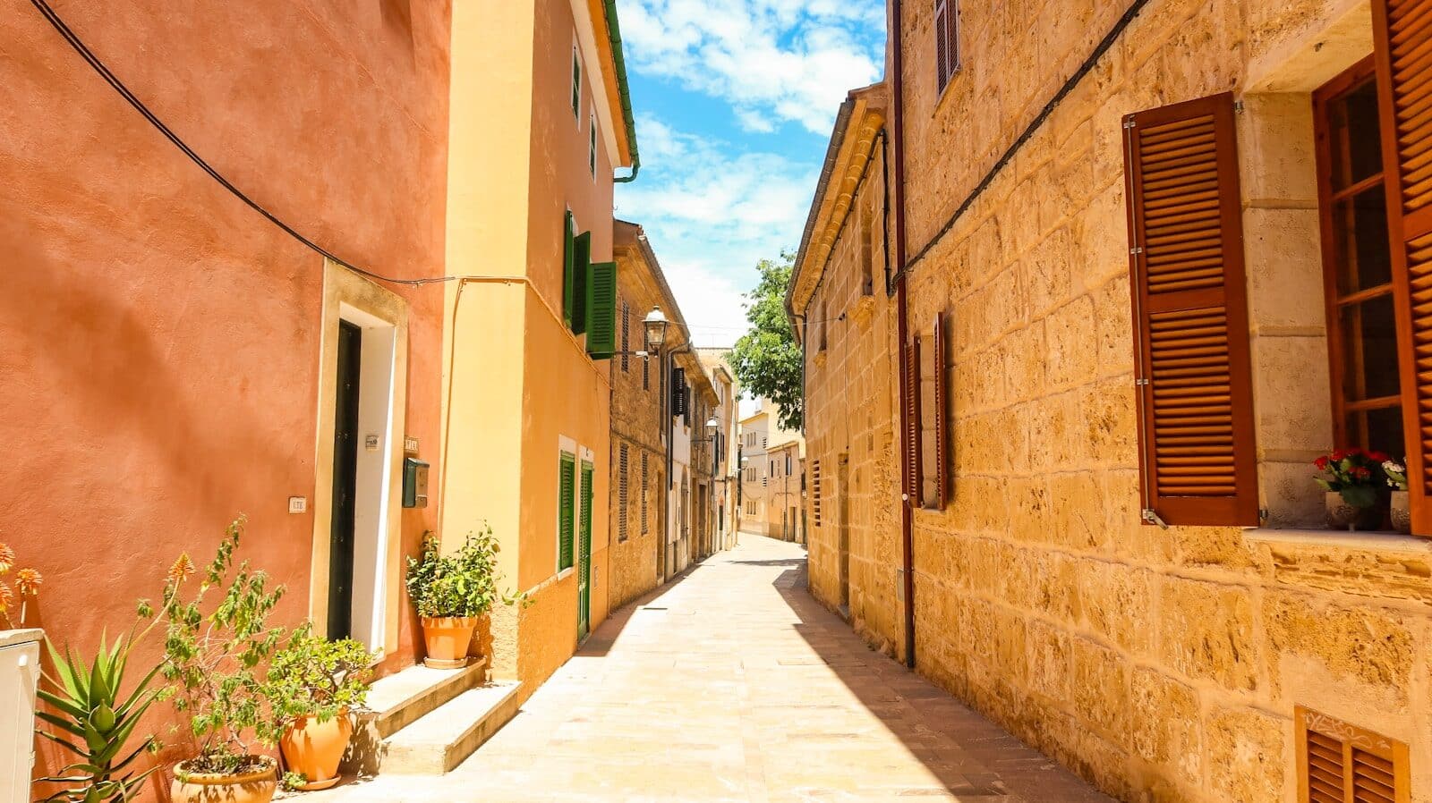 a narrow street with a few windows on each side