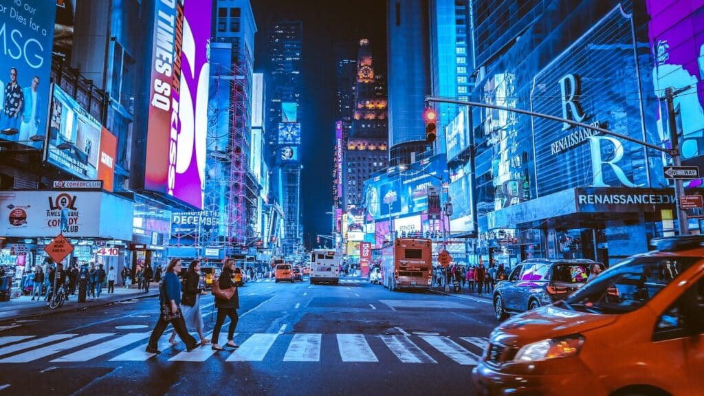 people walking on pedestrian lane during night time