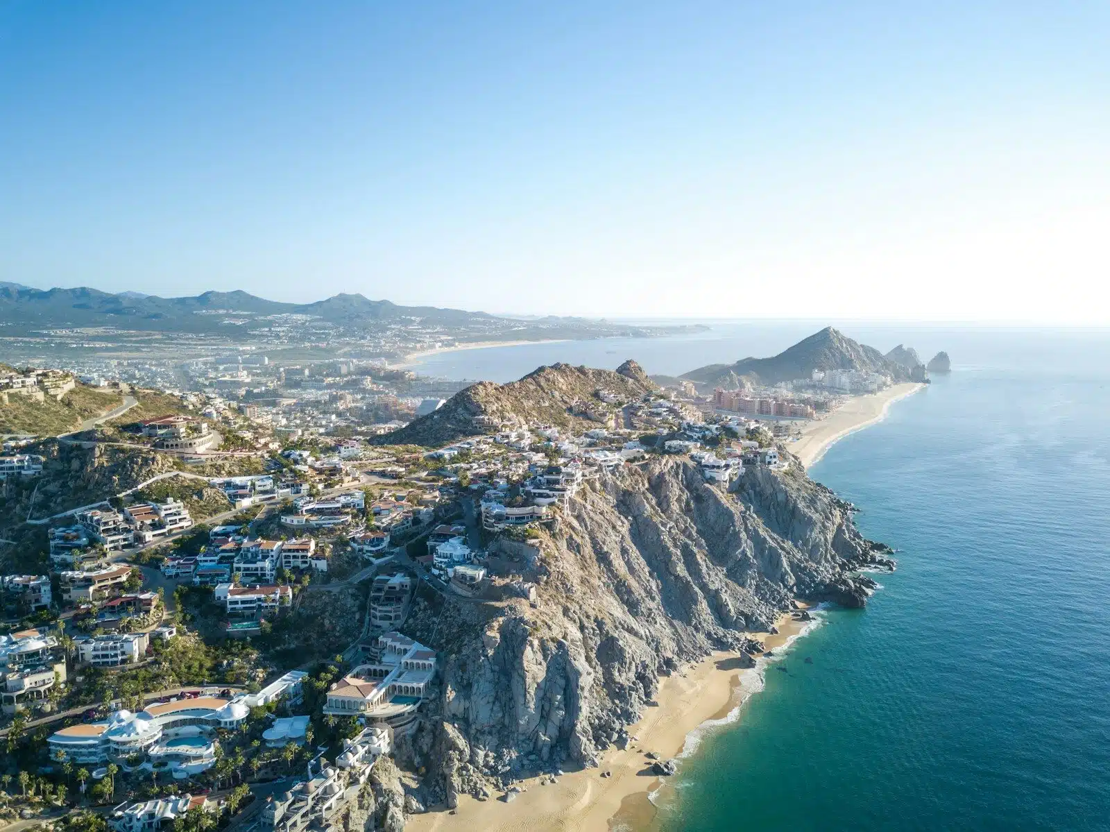 aerial photography of mountain with village near sea