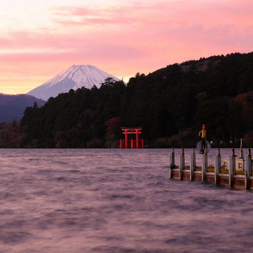 A body of water with a mountain in the background