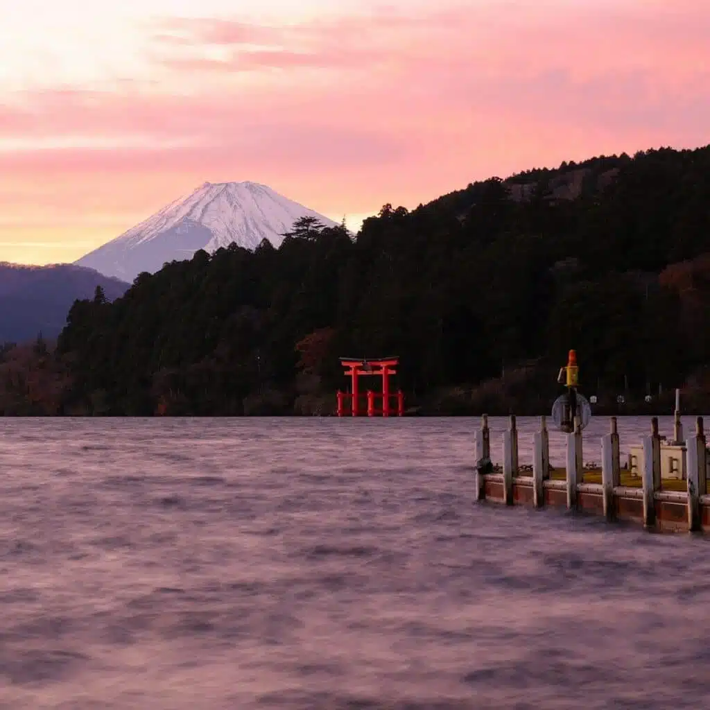 A body of water with a mountain in the background