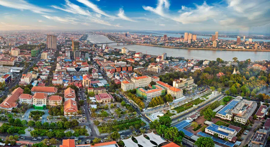 An aerial view of Phnom Penh's skyline with the Mekong River winding through the city.