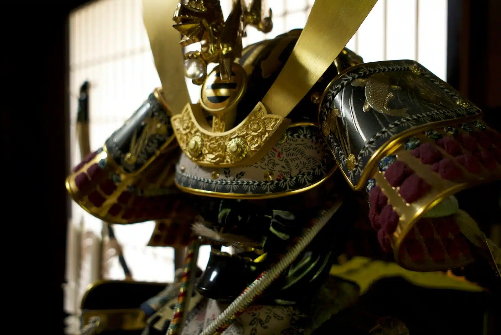 A traditional Japanese samurai helmet with gold ornaments and black lacquered plates